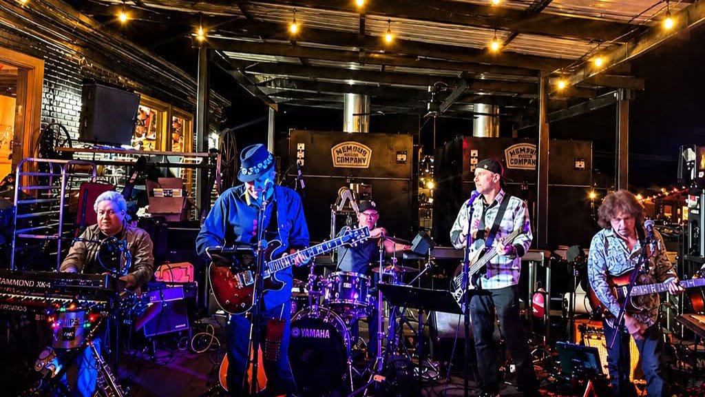 Alibi band performing at night outdoors
